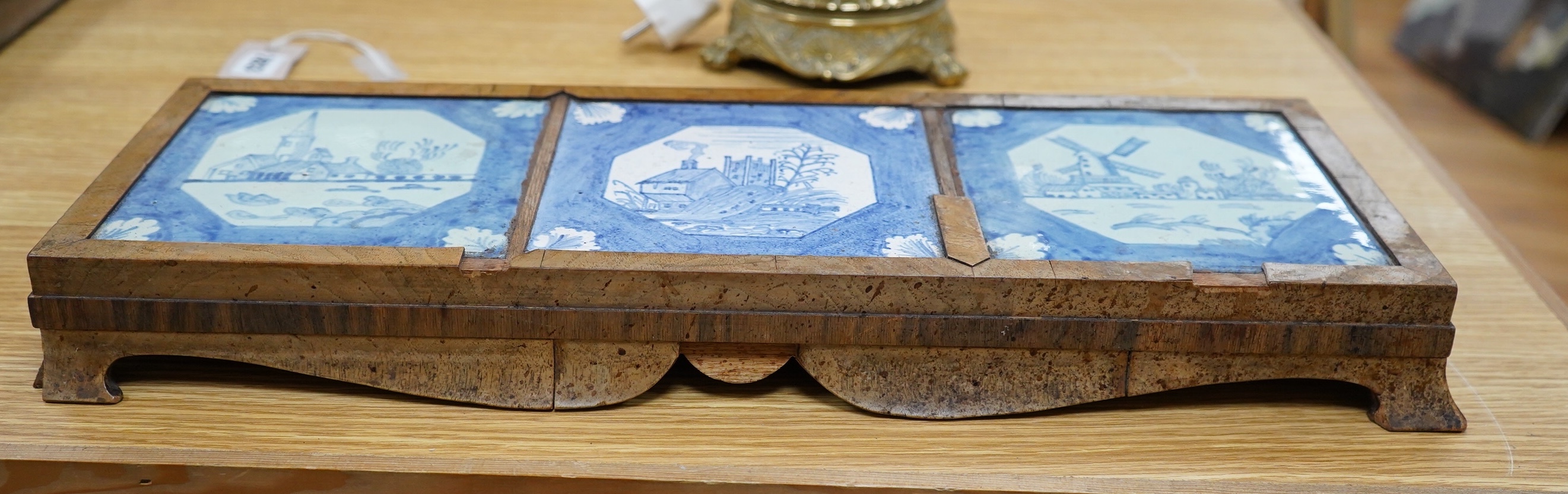 A 19th century Delft tile inset walnut stand, 49cm wide. Condition - poor